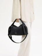 Songmont Drippy Roof Bag Onyx - carried by hand with the strap hanging