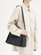 Songmont Drippy Roof Bag Onyx - worn over the shoulder with the long strap