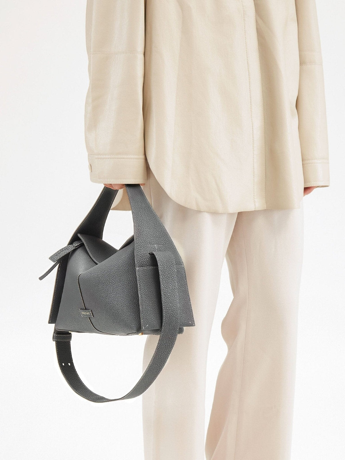 Songmont Drippy Roof Bag Stardust - carried by hand with the strap hanging