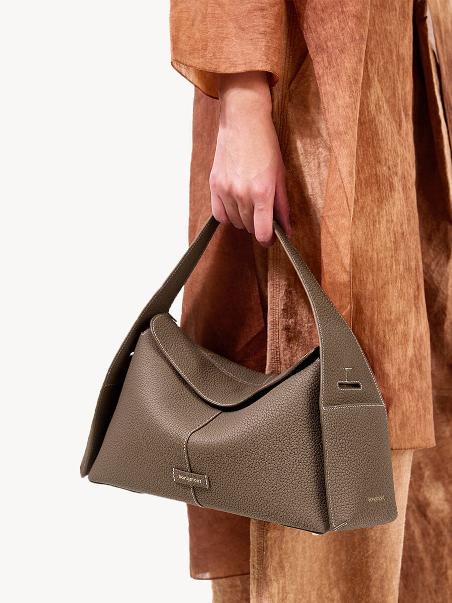 Songmont Drippy Roof Bag Taupe - carried by the top handle