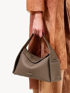Songmont Drippy Roof Bag Taupe - carried by the top handle