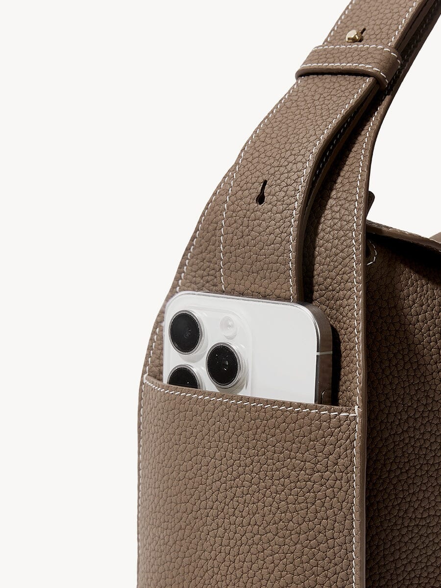 Songmont Drippy Roof Bag Taupe - phone resting in the strap pocket, close-up