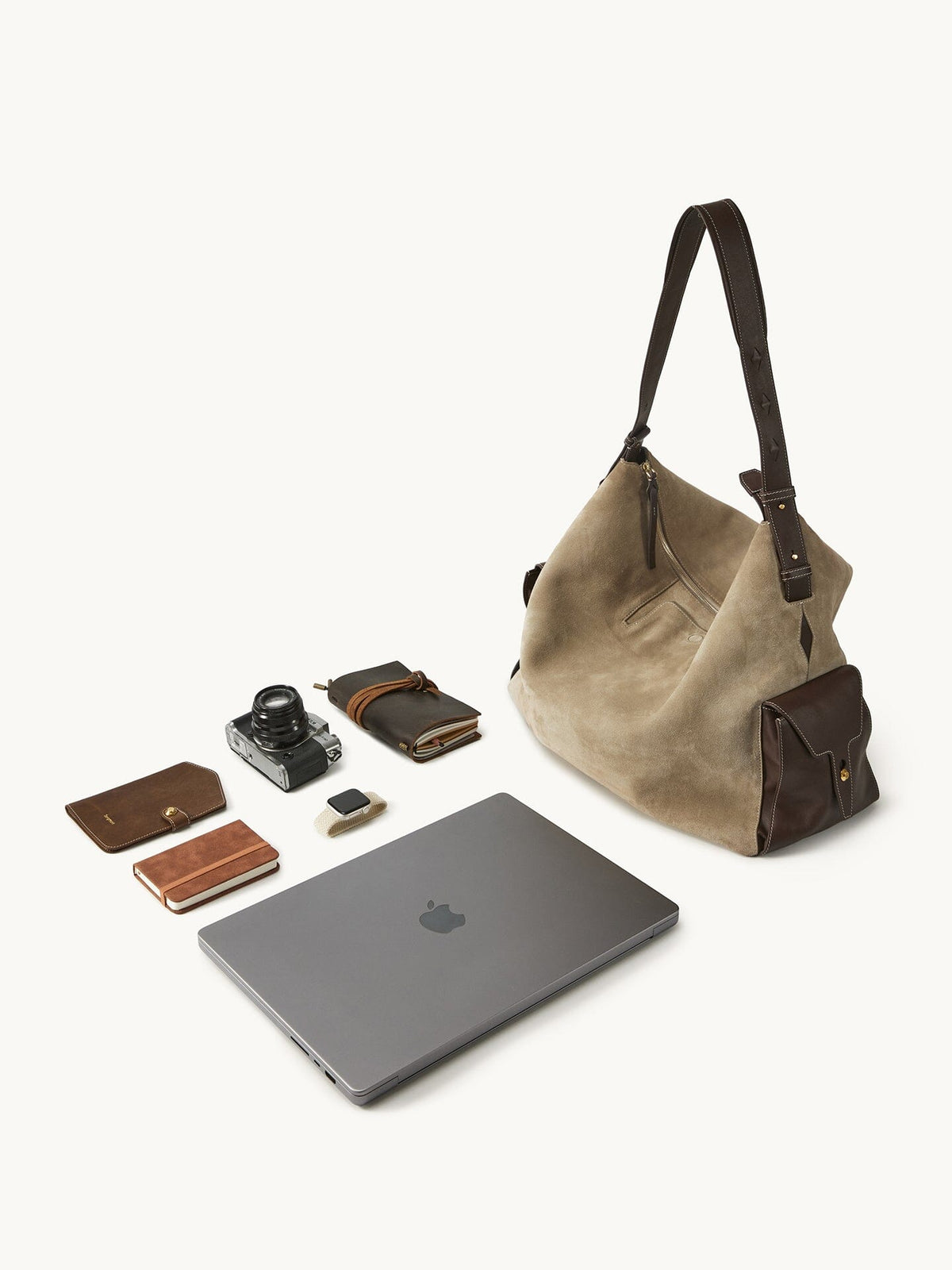 Songmont Extra Large Yore Hobo Bag Dune Suede - flat lay with laptop, camera and notebook