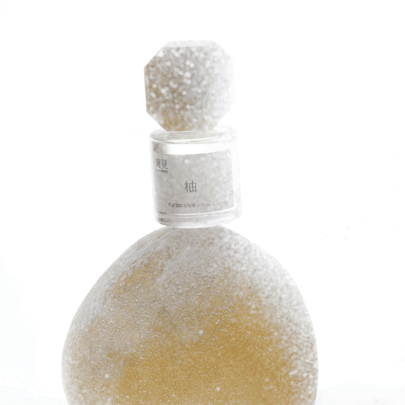 TO SUMMER Pomelo Eau de Parfum bottle on frosted pomelo