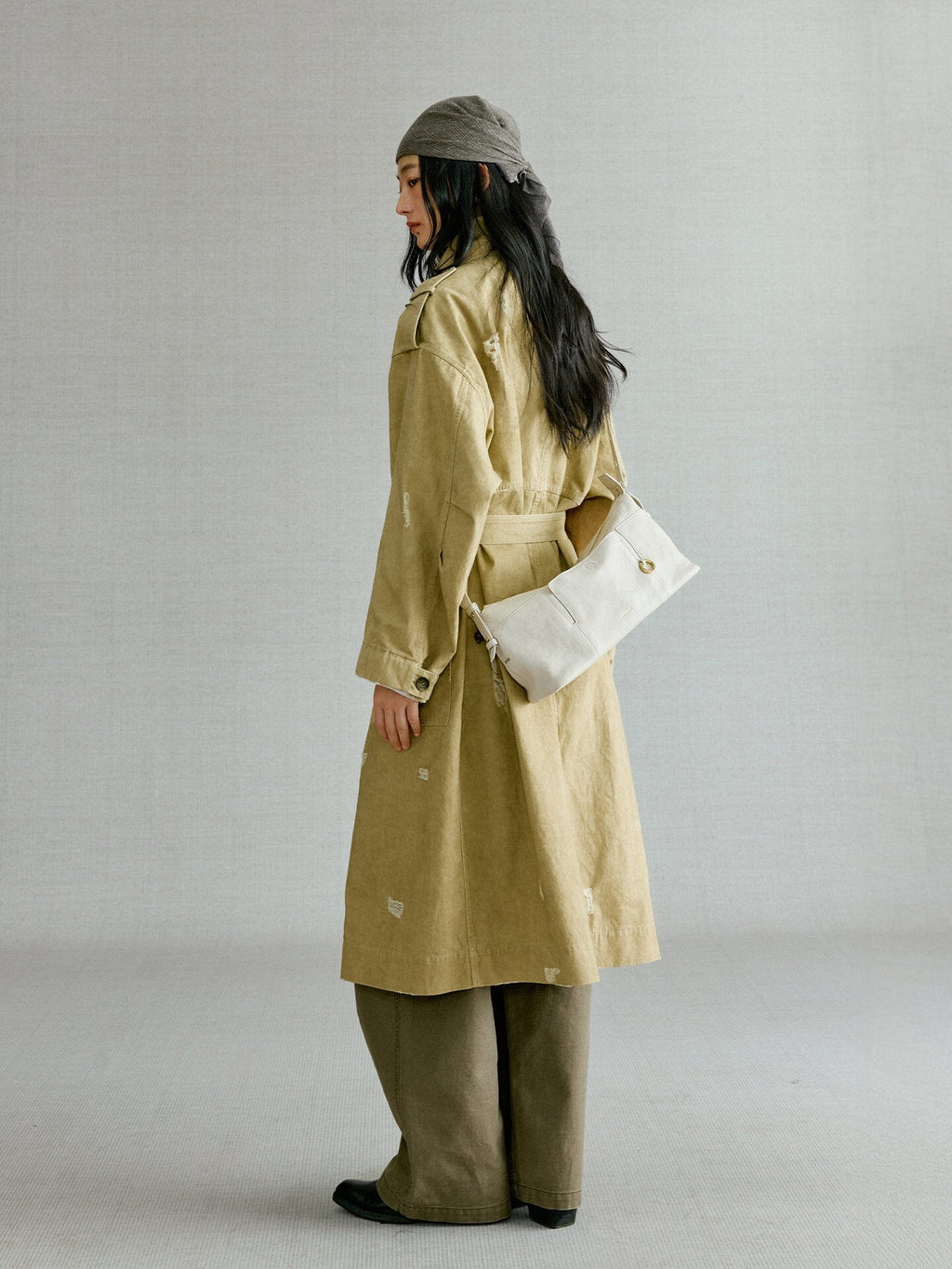 Songmont H Yore Bag Cloud - side view worn at the hip with a trench coat