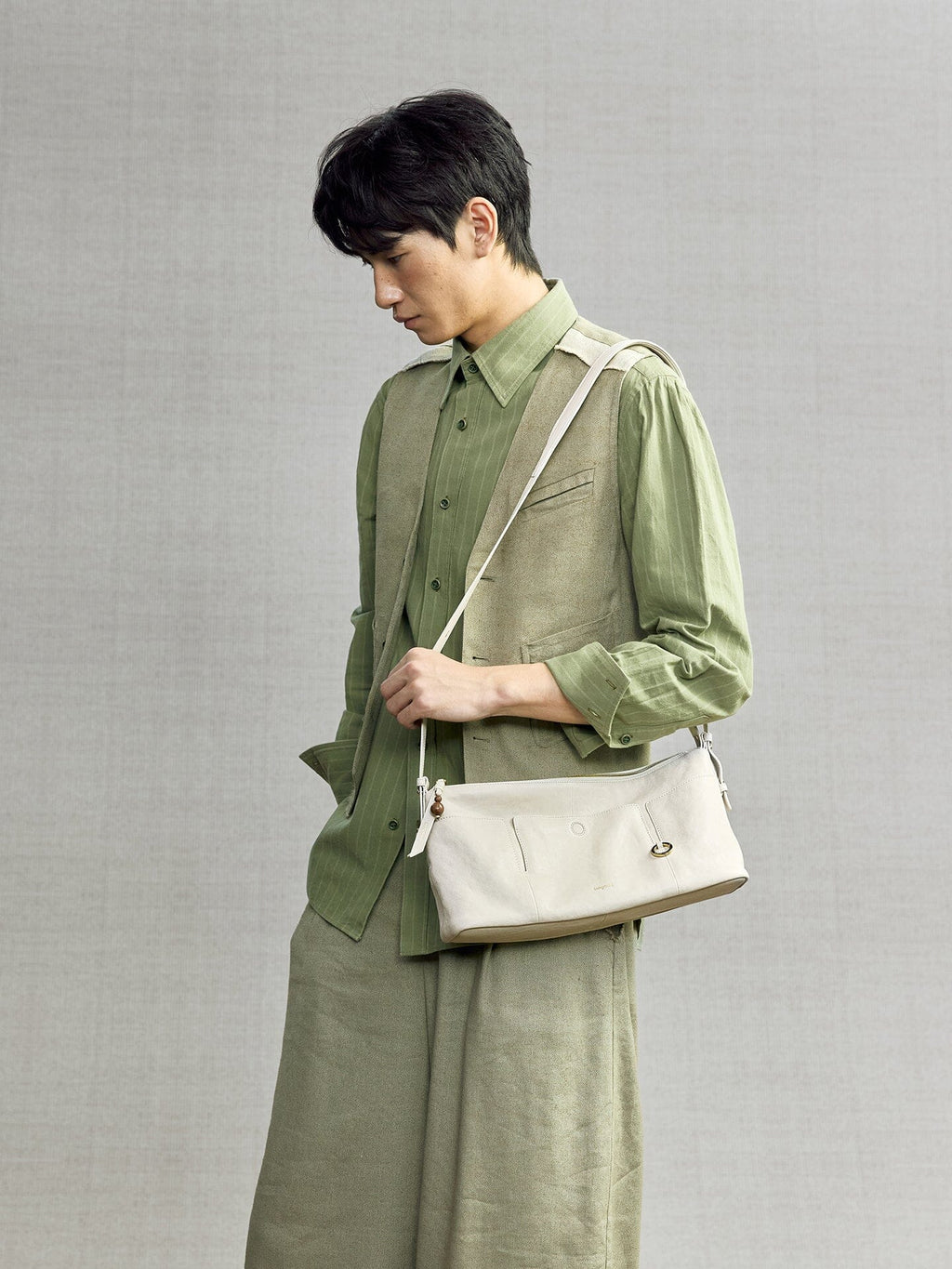 Songmont H Yore Bag Cloud - carried across the body with a green linen outfit