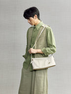 Songmont H Yore Bag Cloud - carried across the body with a green linen outfit