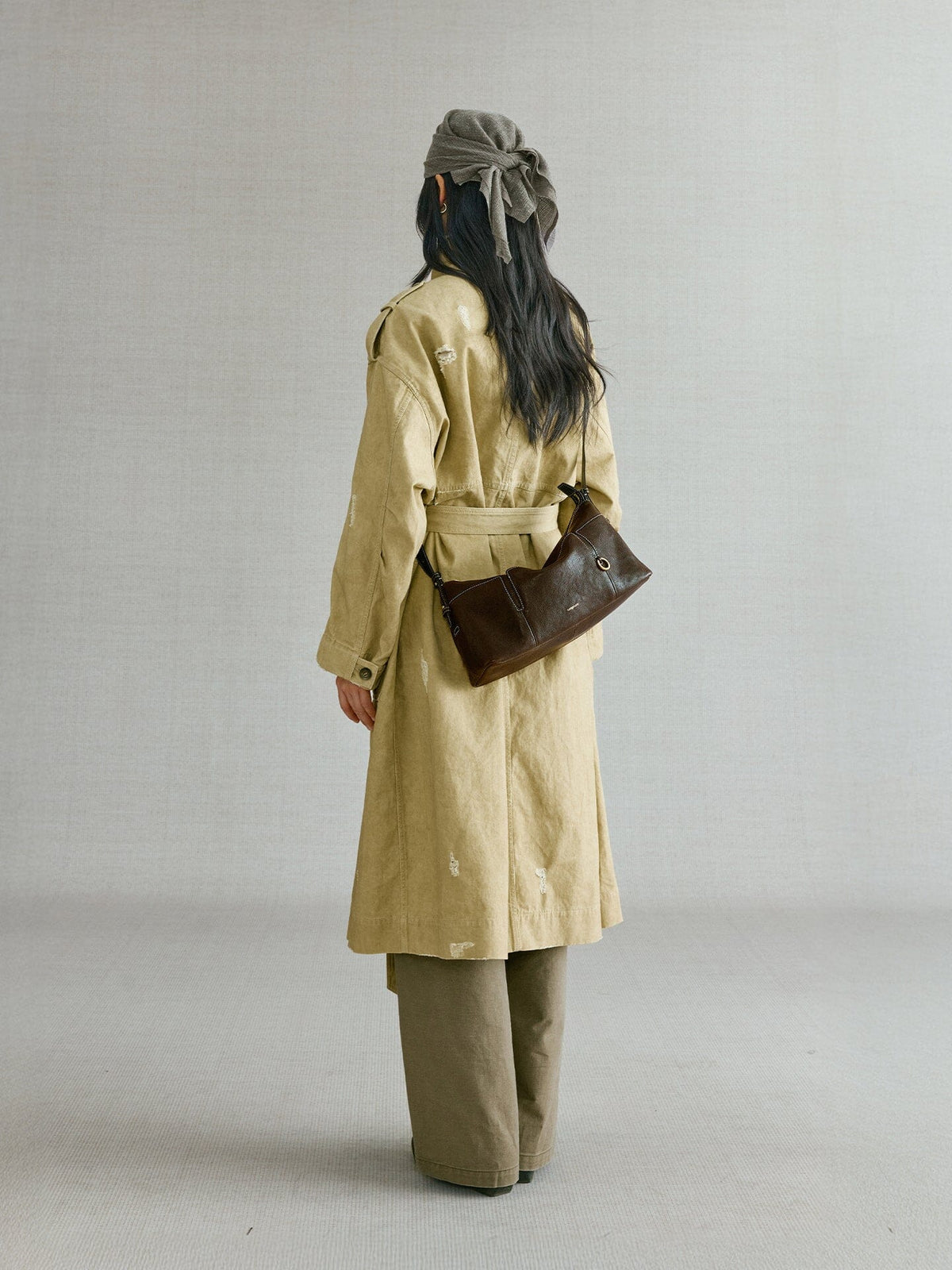 Songmont H Yore Bag Drab - back view worn at the hip with a trench coat