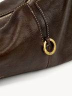 Songmont H Yore Bag Drab - close-up of the gold ring on brown leather
