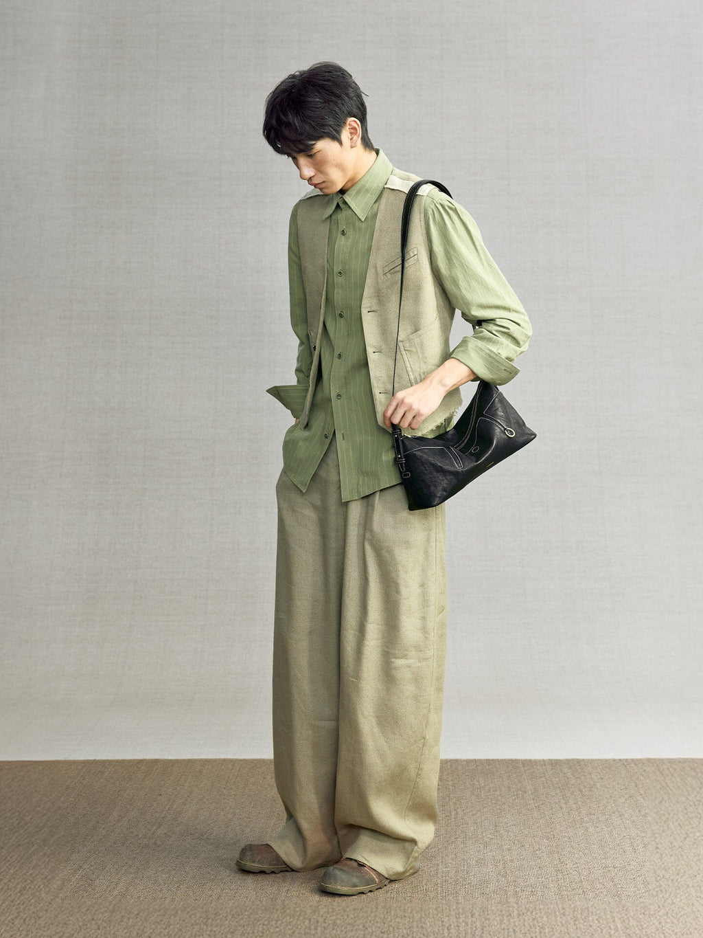 Songmont H Yore Bag Onyx - carried at the hip with a green linen outfit