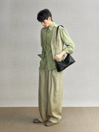 Songmont H Yore Bag Onyx - carried at the hip with a green linen outfit