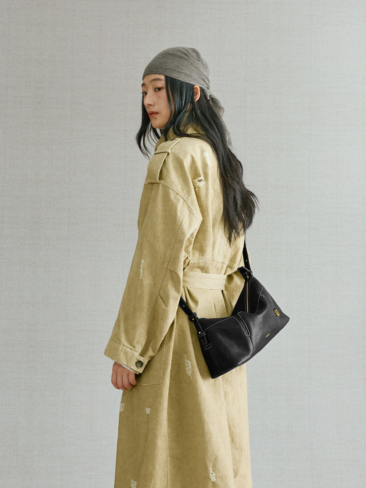 Songmont H Yore Bag Onyx - worn on the shoulder with a khaki trench coat