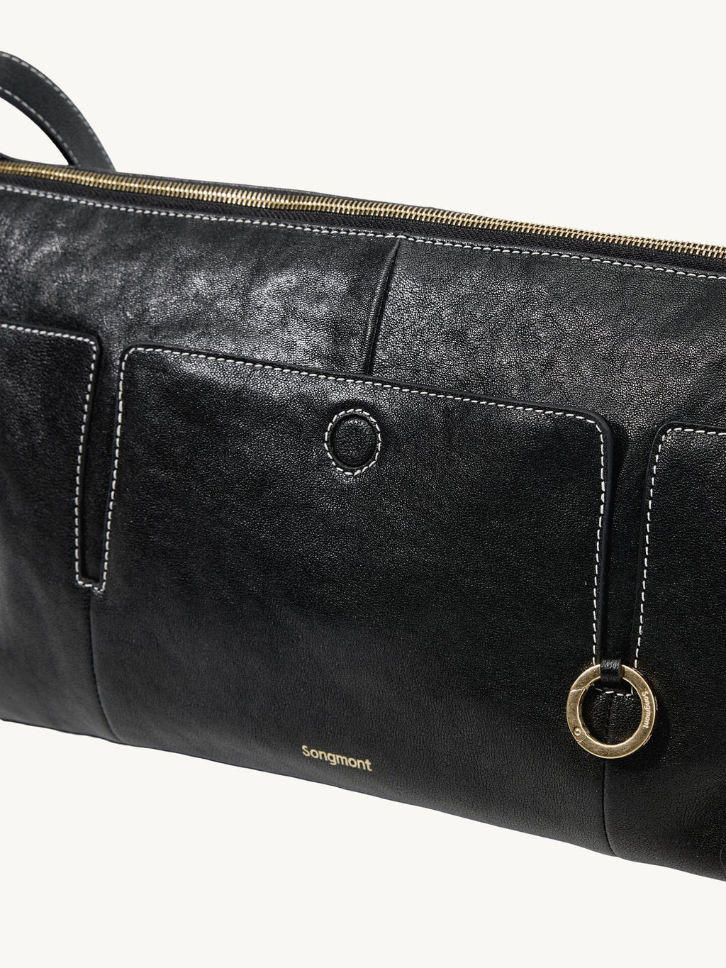Songmont H Yore Bag Onyx - front pocket and gold ring close-up
