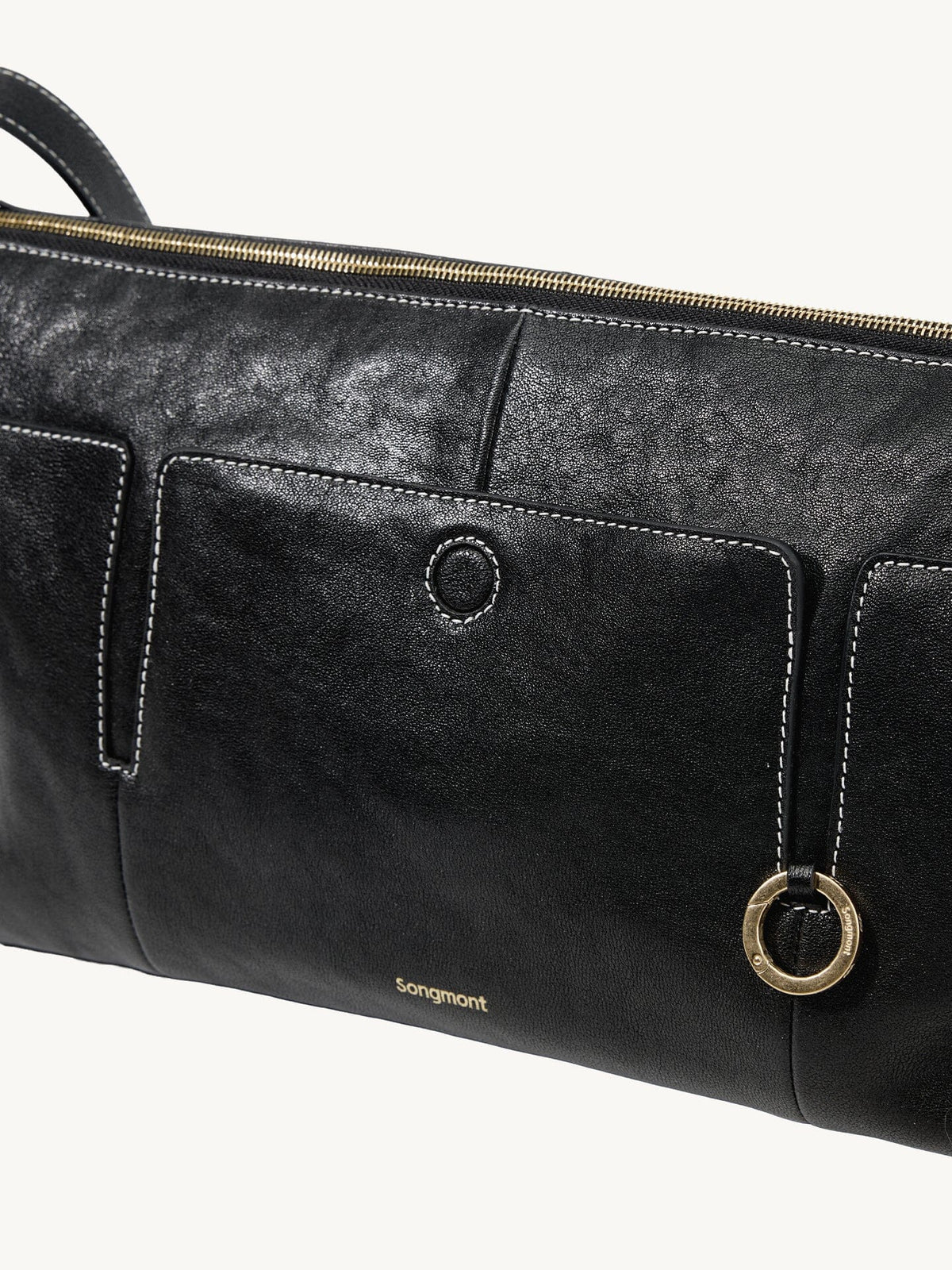 Songmont H Yore Bag Onyx - front pocket and gold ring close-up