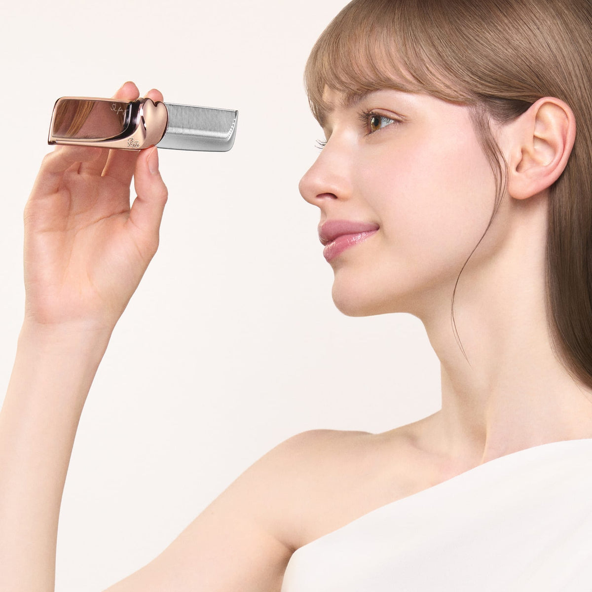 ReFa AIRA MIRROR COMB checking the mirror