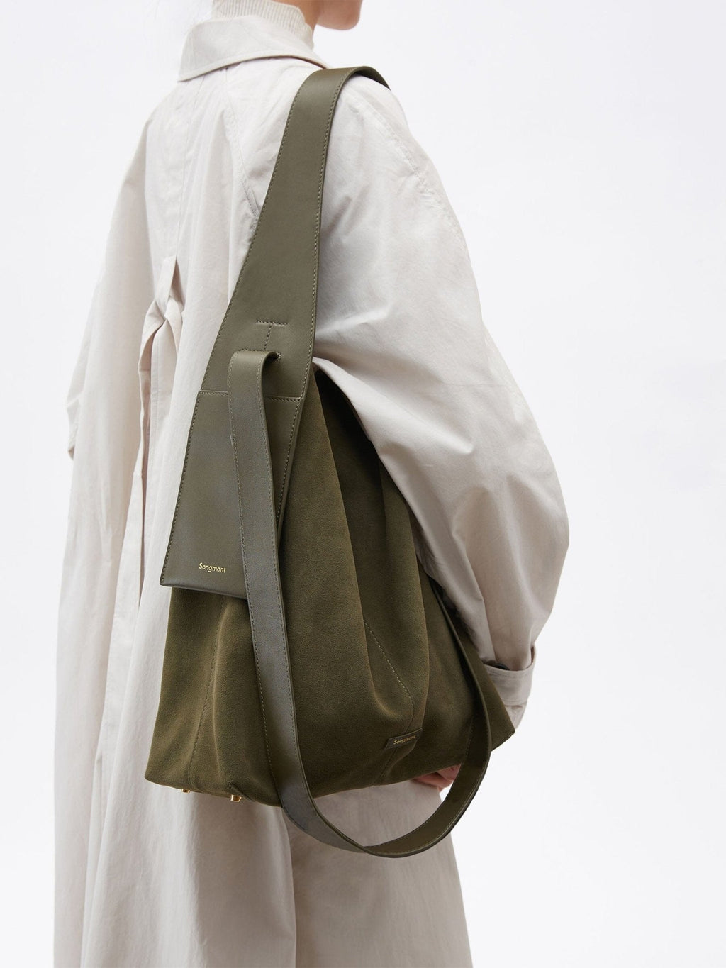 Songmont Large Drippy Tote Bag Olive - worn on the shoulder with a cream trench coat