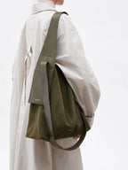 Songmont Large Drippy Tote Bag Olive - worn on the shoulder with a cream trench coat