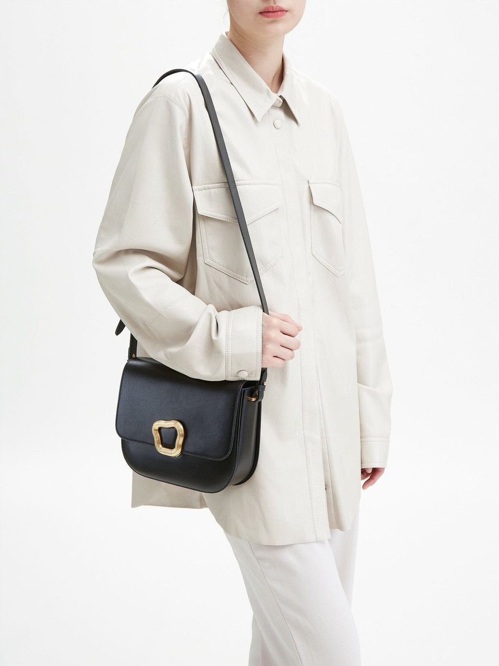 Songmont Large Reset Tofu Bag Onyx - worn on the shoulder with a cream shirt jacket