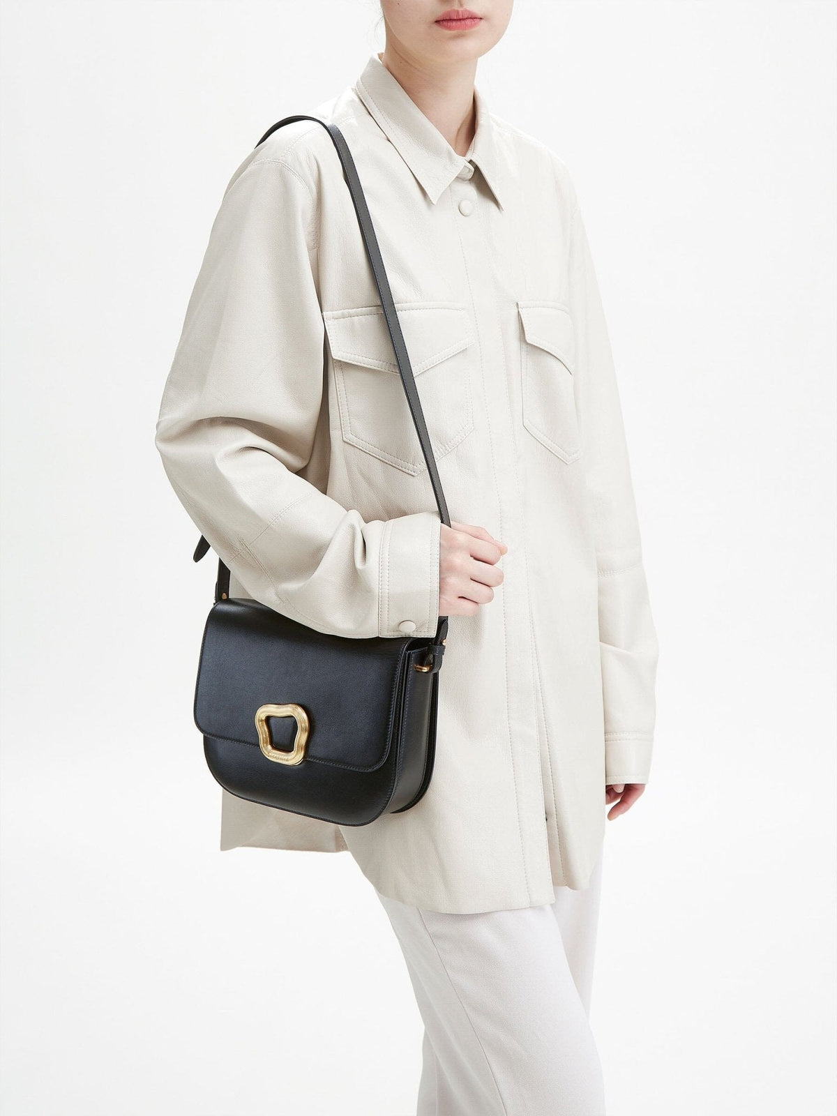 Songmont Large Reset Tofu Bag Onyx - worn on the shoulder with a cream shirt jacket