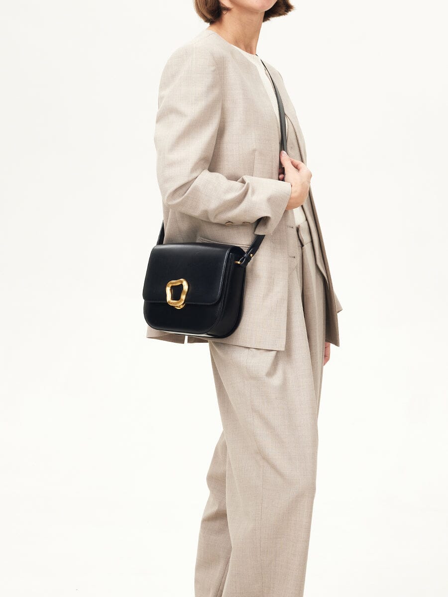 Songmont Large Reset Tofu Bag Onyx - carried at the hip with a beige suit