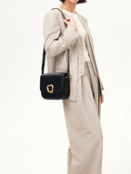 Songmont Large Reset Tofu Bag Onyx - worn cross-body with a light beige suit