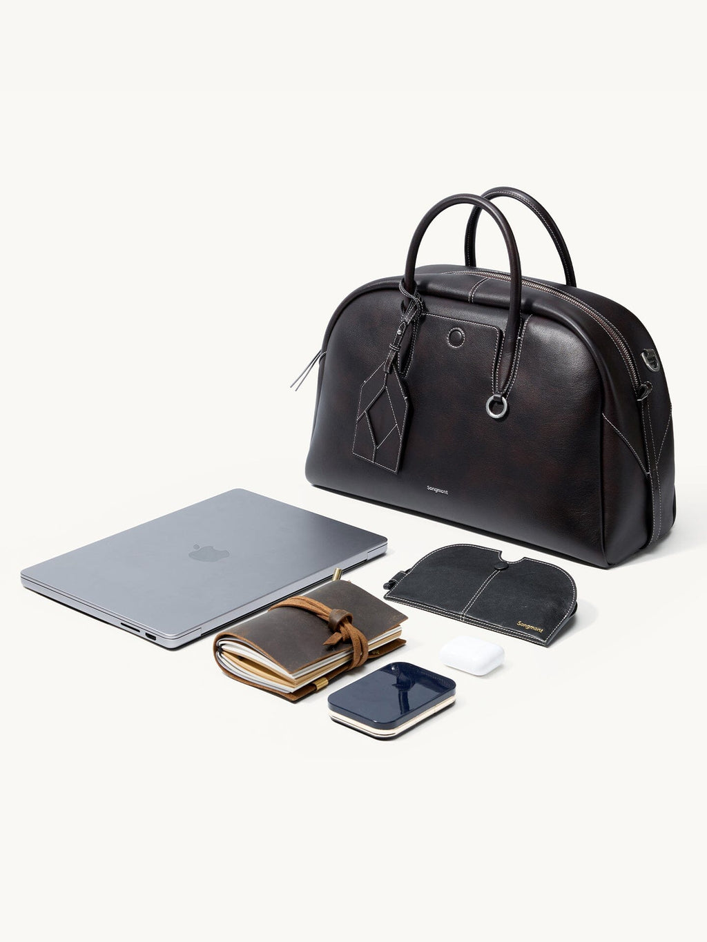 Songmont Large Yore Bowling Bag Ebony - flat lay with a laptop and desk items