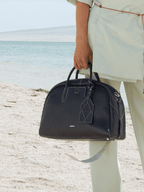 Songmont Large Yore Bowling Bag Ebony - carried by the twin top handles