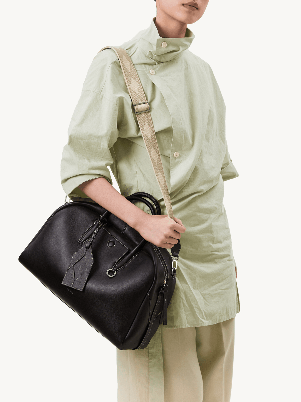 Songmont Large Yore Bowling Bag Ebony - worn cross-body with the woven strap