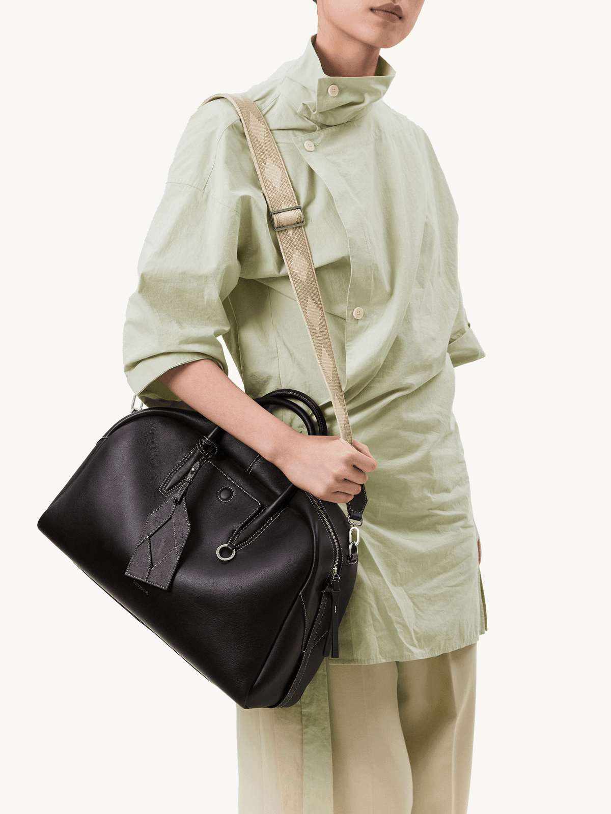 Songmont Large Yore Bowling Bag Ebony - worn cross-body with the woven strap