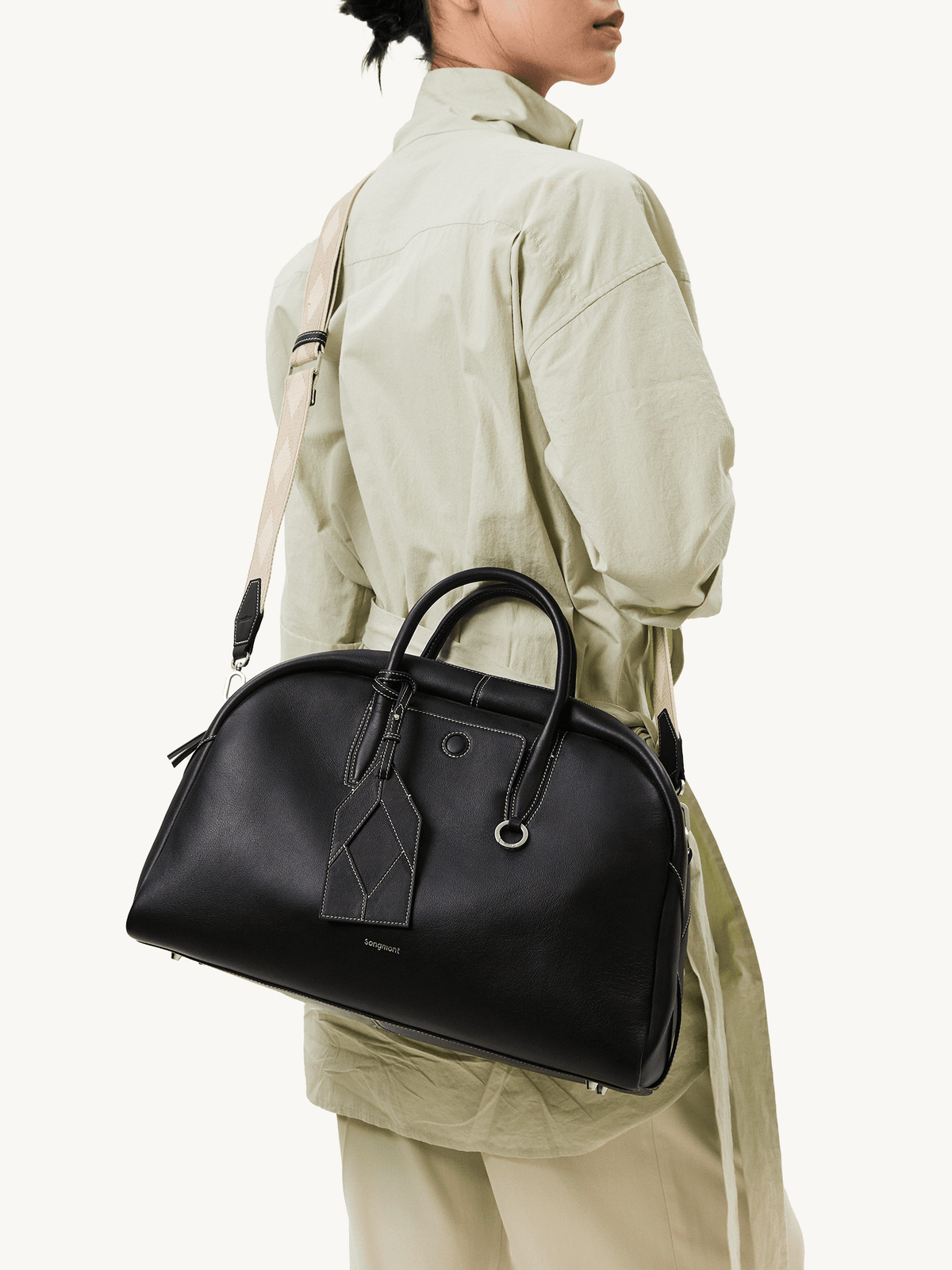 Songmont Large Yore Bowling Bag Ebony - worn on the shoulder, side view
