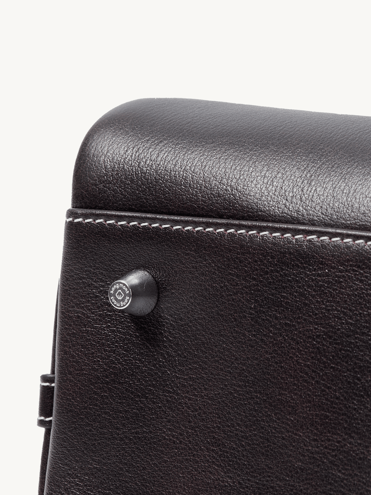 Songmont Large Yore Bowling Bag Ebony - close-up of the stud and contrast stitching