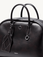 Songmont Large Yore Bowling Bag Ebony - close-up of the top handles and charm tag