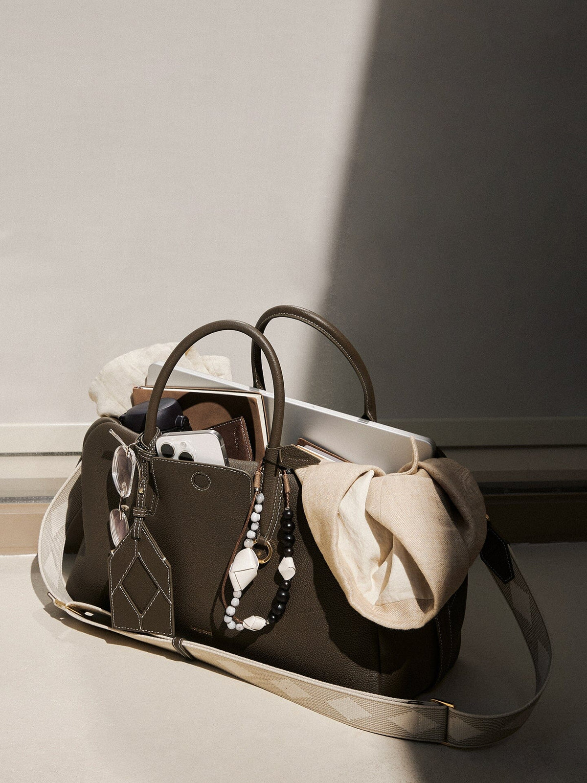 Songmont Large Yore Bowling Bag Moss - unzipped with a laptop and scarf inside