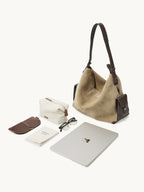 Songmont Large Yore Hobo Bag Dune Suede - laid out with a laptop, glasses and pouch