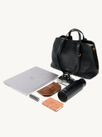 Songmont Large Yore Tote Bag Onyx - with a laptop, camera, bottle and notebook laid out