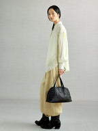 Songmont Lattice Shellseeker Bag Onyx - carried by hand