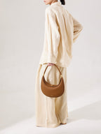 Songmont Luna Bag Mocha - carried by the top handle