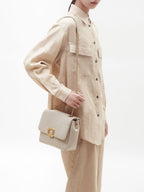 Songmont Medium Chocolate Bag Pearl Grey - carried on the shoulder with a gold chain strap