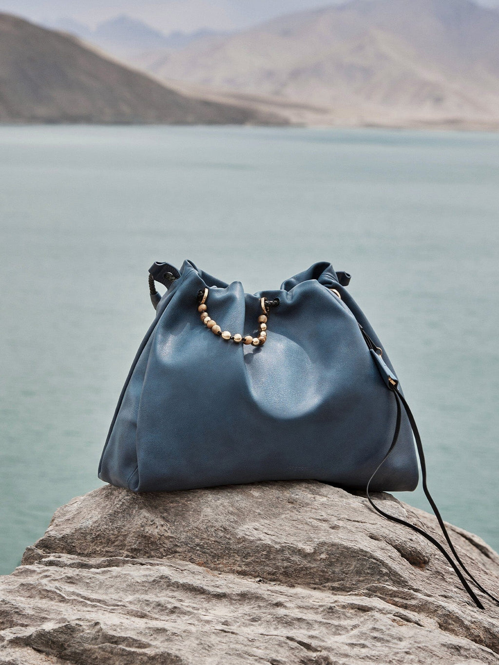 Songmont Medium Gather Bag - Navy with beaded drawstring, outdoor setting