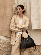 Songmont Medium Gather Bag - Onyx worn, adjustable strap and drawstring closure