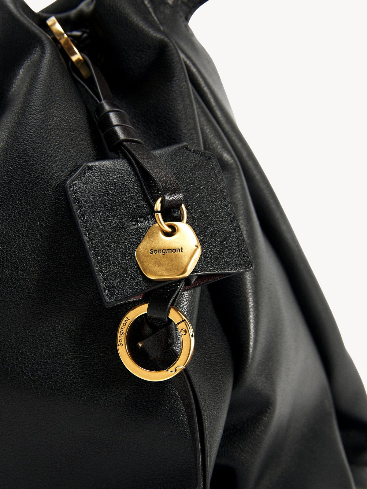 Songmont Medium Gather Bag - Onyx leather texture with logo detail