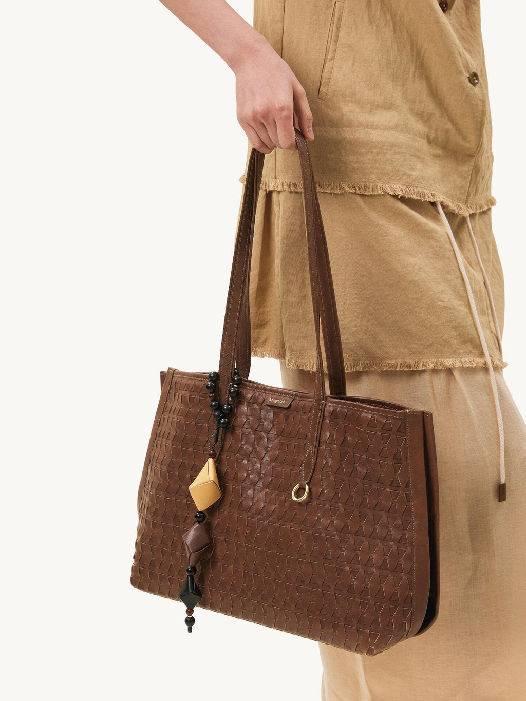 Songmont Medium Lattice Tote Sandal - carried by hand