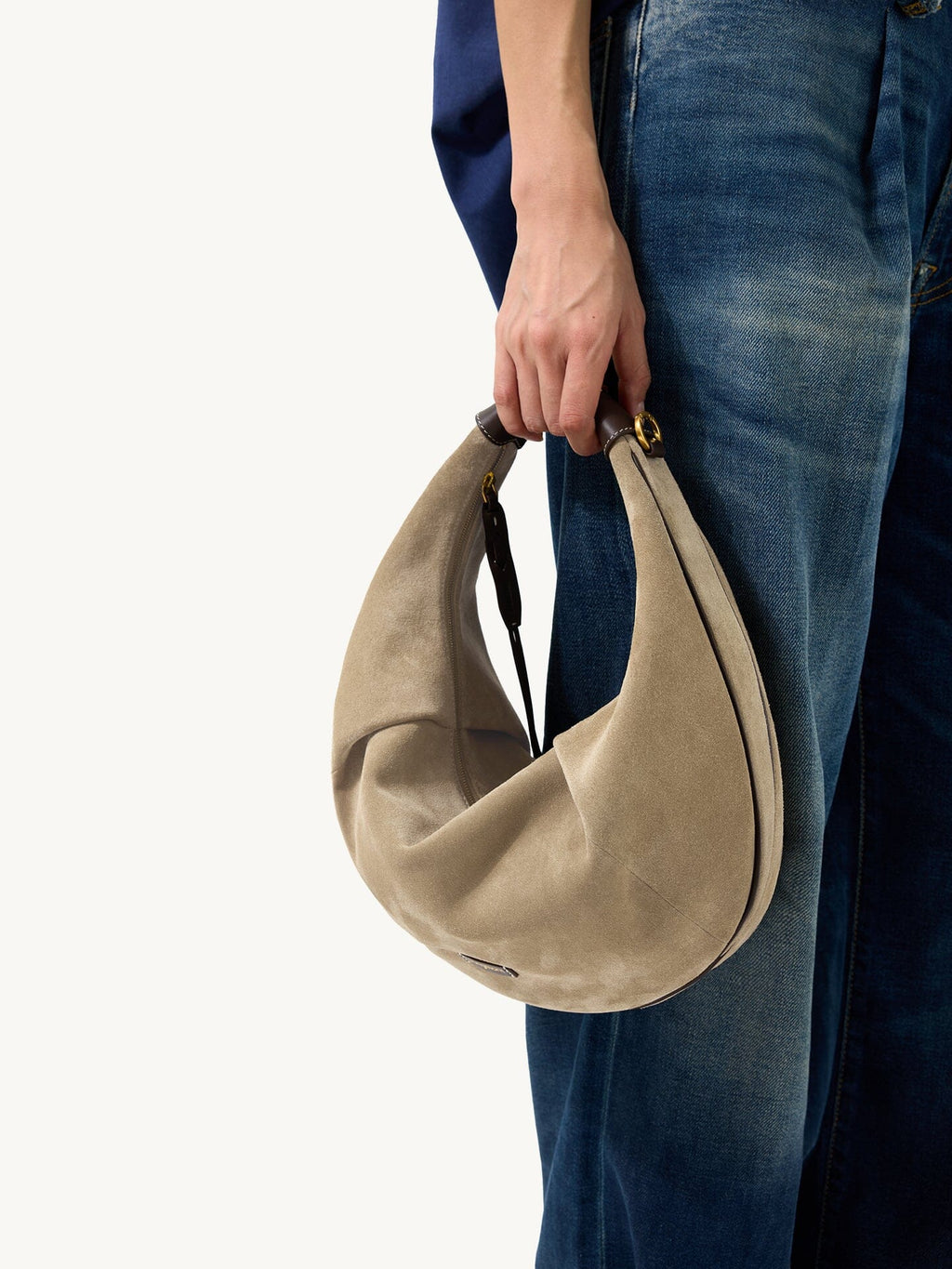 Songmont Large Luna Hobo Bag Dune Suede - carried by hand beside denim