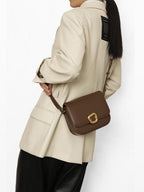 Songmont Medium Reset Tofu Bag Caramel - worn crossbody with a cream blazer