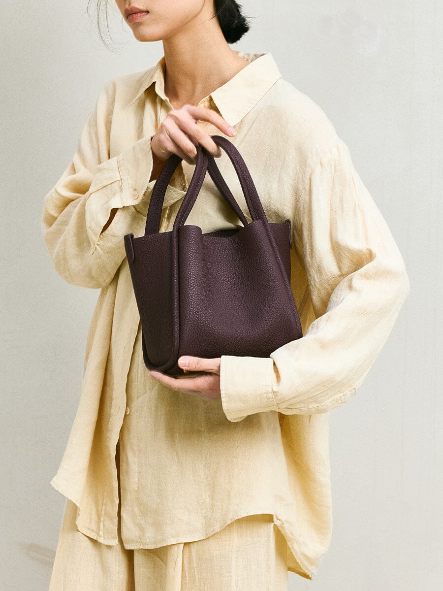 Songmont Medium Song Bag Burgundy held in the arms