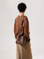Songmont Medium Song Bag Chocolate worn on the shoulder, rear view