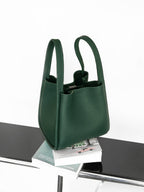 Songmont Medium Song Bag Emerald on a ledge