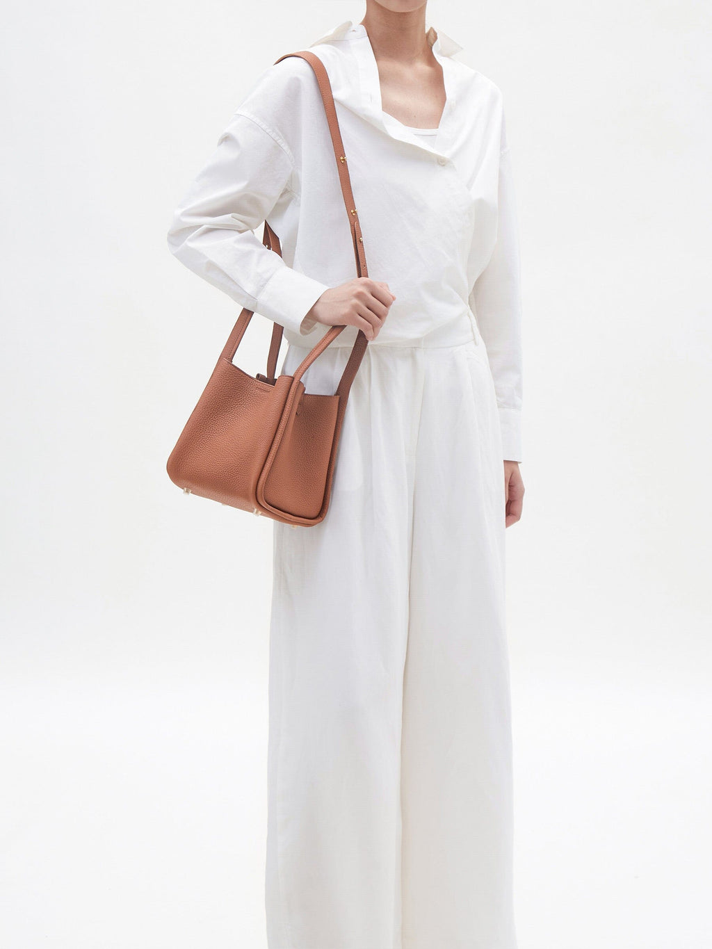 Songmont Medium Song Bag Golden Brown worn on the shoulder