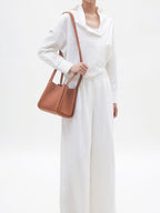 Songmont Medium Song Bag Golden Brown worn on the shoulder