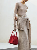 Songmont Medium Song Bag Poppy held with knitwear